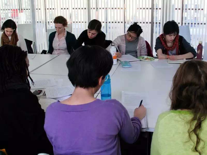 A group of students in a classroom taking notes on a reading